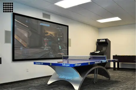 Game room with screen and ping pong table.